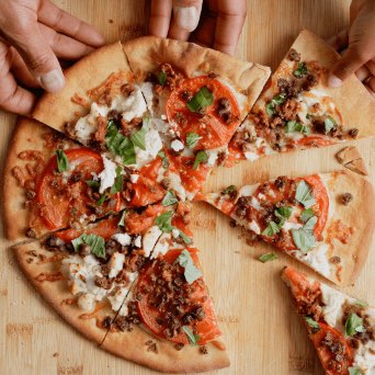 Animated image of hands grabbing pizza slices featuring Beyond 168飞艇官网开奖结果记录数据 Crumbles